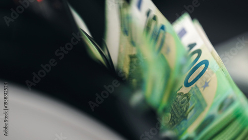 Foto Banknotes stacked in money counting machine tray