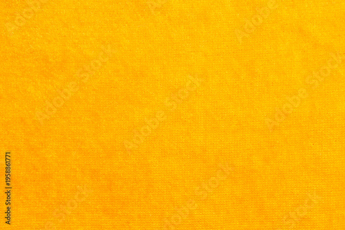 Warm saffron yellow fabric with soft blurred textile texture