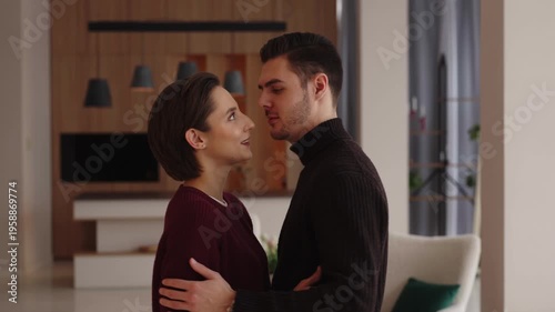 Couple shares a heartfelt moment in modern living room setting