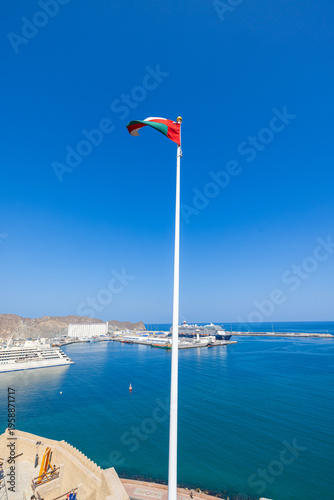 Muscat, Oman – December 28, 2025: View from Mutrah Fort overlooking Muscat harbor with a large cruise ship anchored in the turquoise waters of the Gulf of Oman. The scene captures historic defensive w