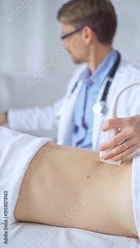 фотографія Doctor man is using ultrasound equipment on the back of a patient, woman