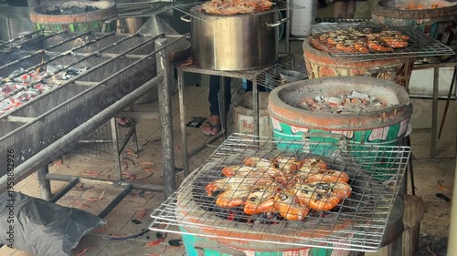 Fresh river prawns grilling over charcoal for Thai-style grilled prawns.