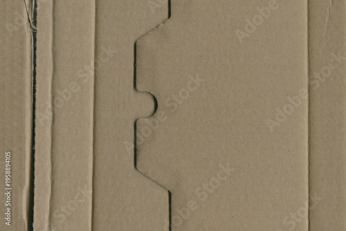 Brown Cardboard background featuring a distinct jagged die-cut edge pattern
