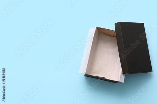 Black empty shoebox on blue...