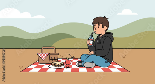 Boy Enjoys Refreshing Drink At A Picturesque Outdoor Picnic Setting
