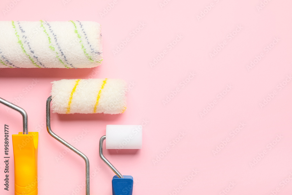 Obraz premium Different paint rollers on pink background