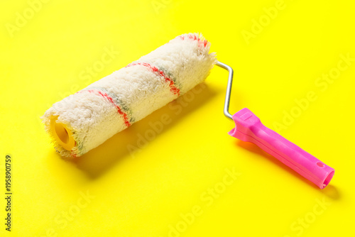 Paint roller on yellow back...