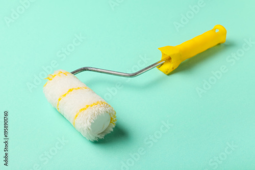 Paint roller on turquoise b...