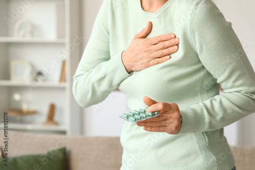 Mature woman with pills hav...