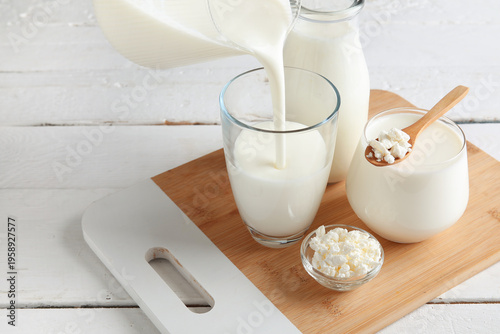 Pouring kefir from jug into...