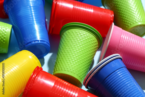 Colorful plastic cups on bl...