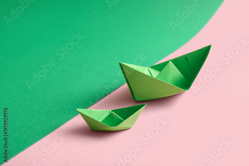 Green origami boats on colo...
