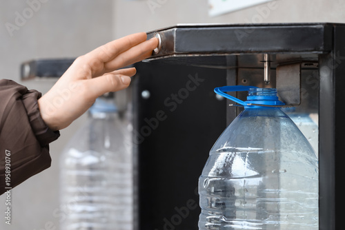 Woman refilling plastic bot...