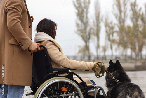 Young woman in wheelchair w...