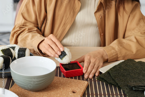Young woman dipping traditi...