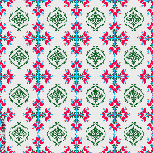 A vibrant seamless pattern in a classic Damask and floral vintage style. The design features ornate, green ornamental emblems interspersed with bright red floral motifs arranged in a symmetrical grid.