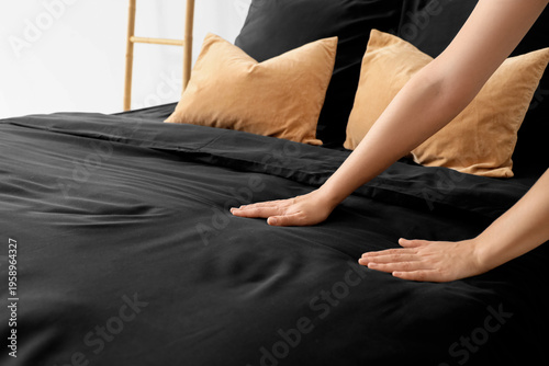 Young woman putting black b...