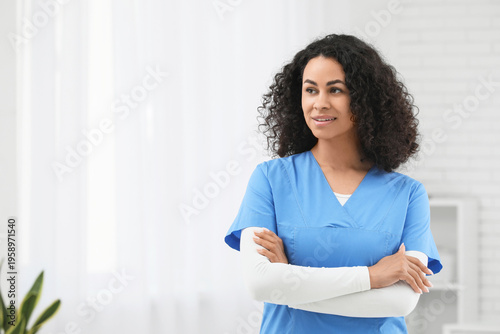 Free Download Beautiful young happy African-American female doctor in clinic - GFXLoad