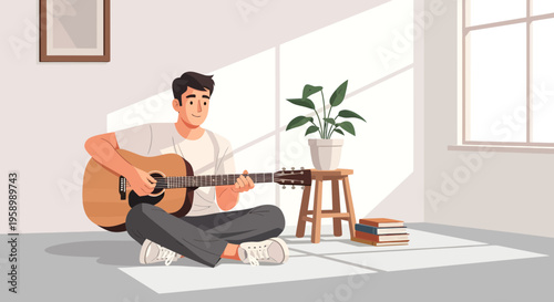 Young man playing acoustic guitar indoors.