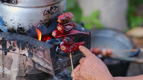 Cooking Process with Fresh Ingredients in Traditional Kitchen, Preparing Spicy Dish with Dry Red Chilies and Pot of Boiling Vegetables on Open Flame
