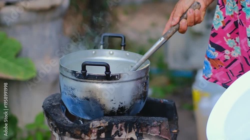 Rustic Cooking Scene with Boiling Pot Over Outdoor Fire, Surrounded by Lush Greenery and Natural Outdoor Environment, Ideal for Culinary Themes