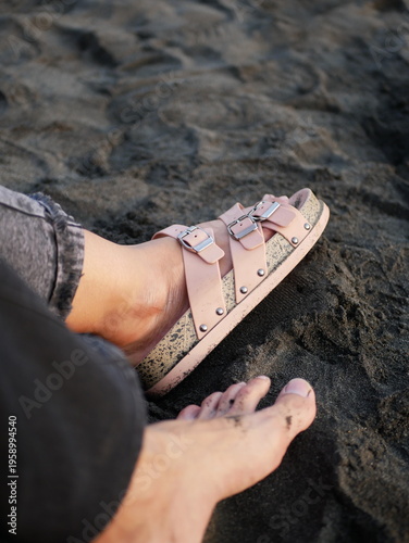 Casual Sandals on Foot by the Shoreline Close Up