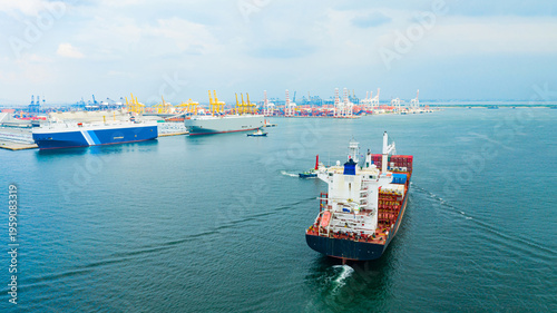 Foto multiple cargo vessels navigating across calm blue water near busy container por