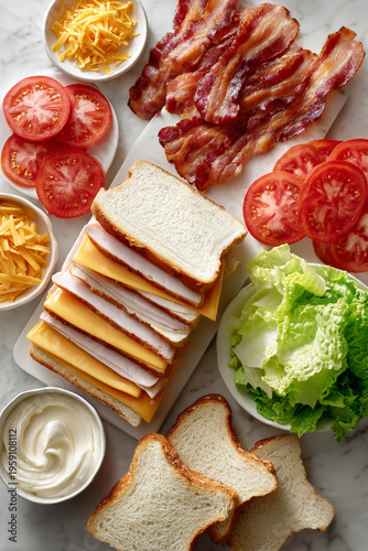 Turkey Club Sandwich ingredients arranged neatly on a light white marble countertop