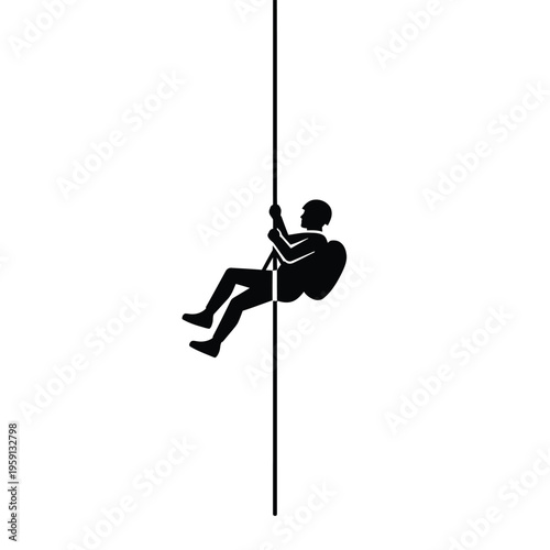 Silhouette of person rappelling down a rope climbing