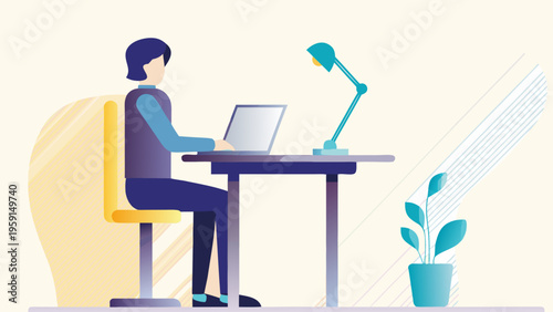 A woman sits at a desk working on her laptop with a lamp and plant nearby