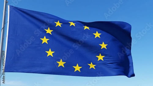 A blue flag with yellow stars waves against a clear blue sky