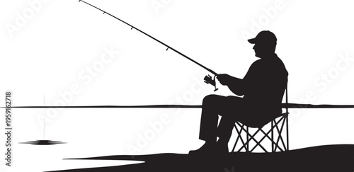 Silhouette of a man fishing alone by the water