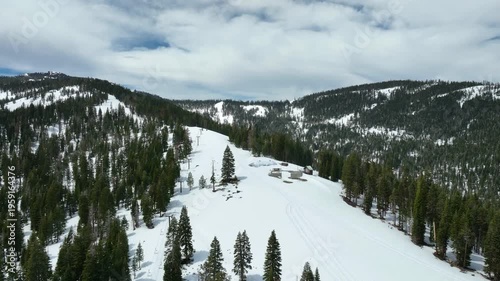 Drone rising over the snowy ski slopes of Homewood Mountain resort, in Tahoe, USA