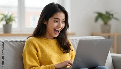 Free Download Young woman with excited expression looking at laptop screen while sitting on a couch - GFXLoad
