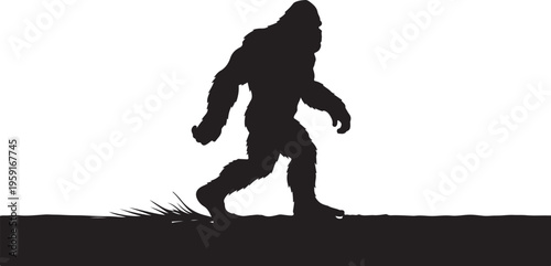 Bigfoot walking on a grassy field at sunset silhouette