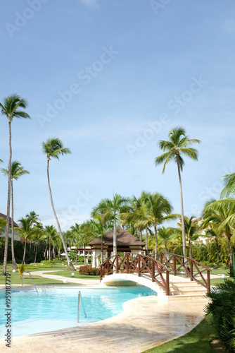 Tropical resort with clear blue pool and palm trees in Punta Cana