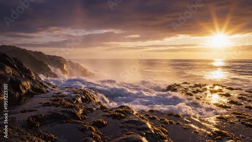 Powerful ocean waves crash against rocky shore at sunset