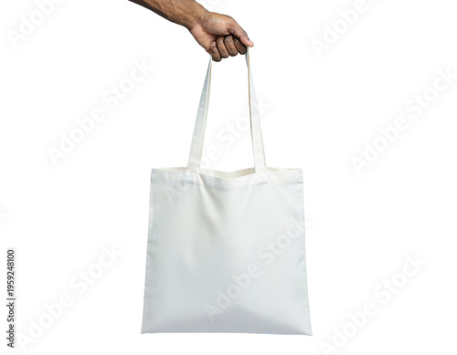 Blank white canvas tote bag mockup held by man hand on top handle centered isolated PNG transparent.