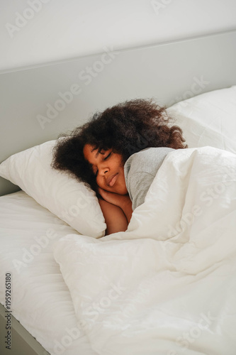 Konstfotografi peaceful sleeping woman under white duvet in bright bedroom morning light
