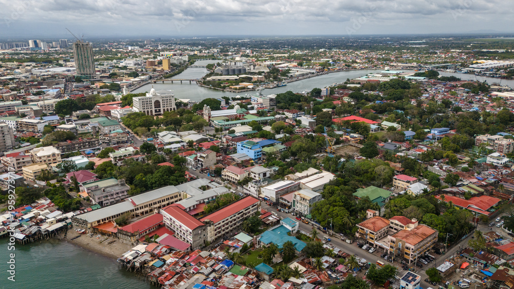Fototapeta premium aerial drone shot of Iloilo City's river esplanade. Showcasing the winding Iloilo River and the vibrant urban texture of the City of Love in the heart of the Philippines