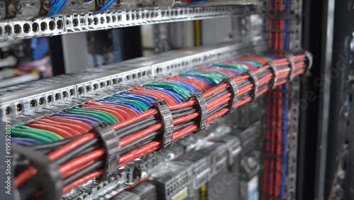 Organized server room with neatly bundled network cables in vibrant colors
