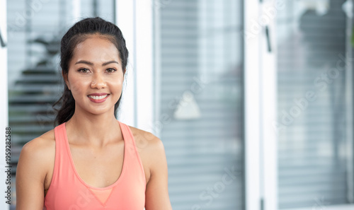 Young Asian woman in sportswear training yoga exercises with online video tutorial on tablet Free Download Young Asian woman in sportswear training yoga exercises with online video tutorial on tablet - GFXLoad