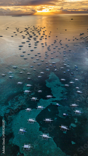 sunset aerial drone view of Alona Beach on Panglao Island, Bohol, Philippine travel holiday destination 