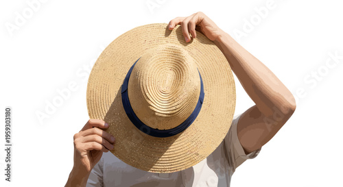 Woman holding straw hat in front of face on white background