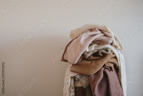 Soft Textured Wool Sweaters In A Neutral Palette Stacked For Winter Organization