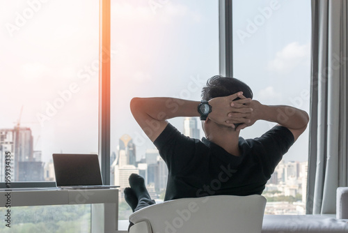 Work-life balance and living life style concept of businessman relaxing, take it easy in hotel or office room resting with thoughtful mind thinking of lifestyle quality looking forward to city