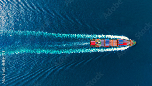 Aerial top view container ship full speed with beautiful wave pattern for logistics.