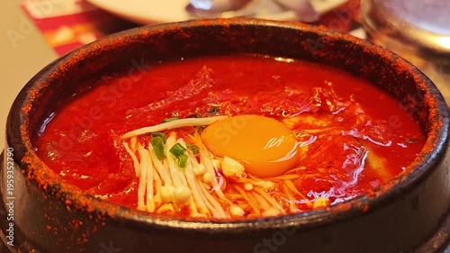 Kimchi soup with egg in a hot pot.