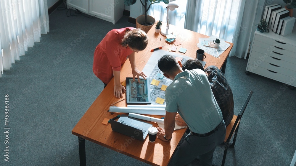 Fototapeta premium Top view of smart civil engineer team working together to plans building construction. Top view of architect designer walking and joining meeting while talking idea while looking at tablet. Symposium.