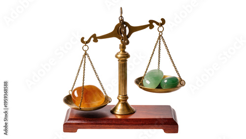 Slika na platnu Classic brass balance scale weighing amber gemstone against two green polished s